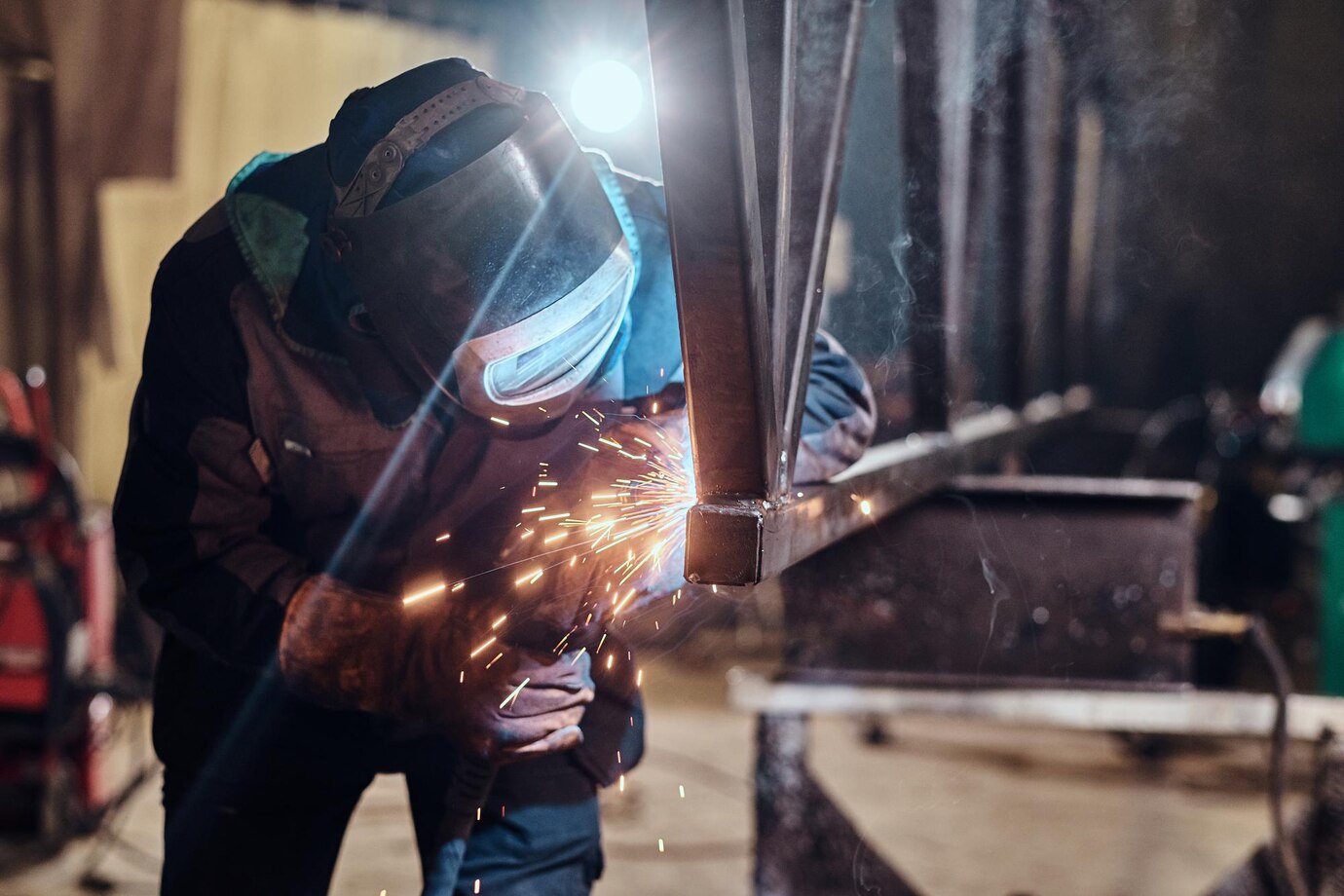 man-is-working-metal-factory-he-is-welding-piece-rail-using-special-tools_613910-3861